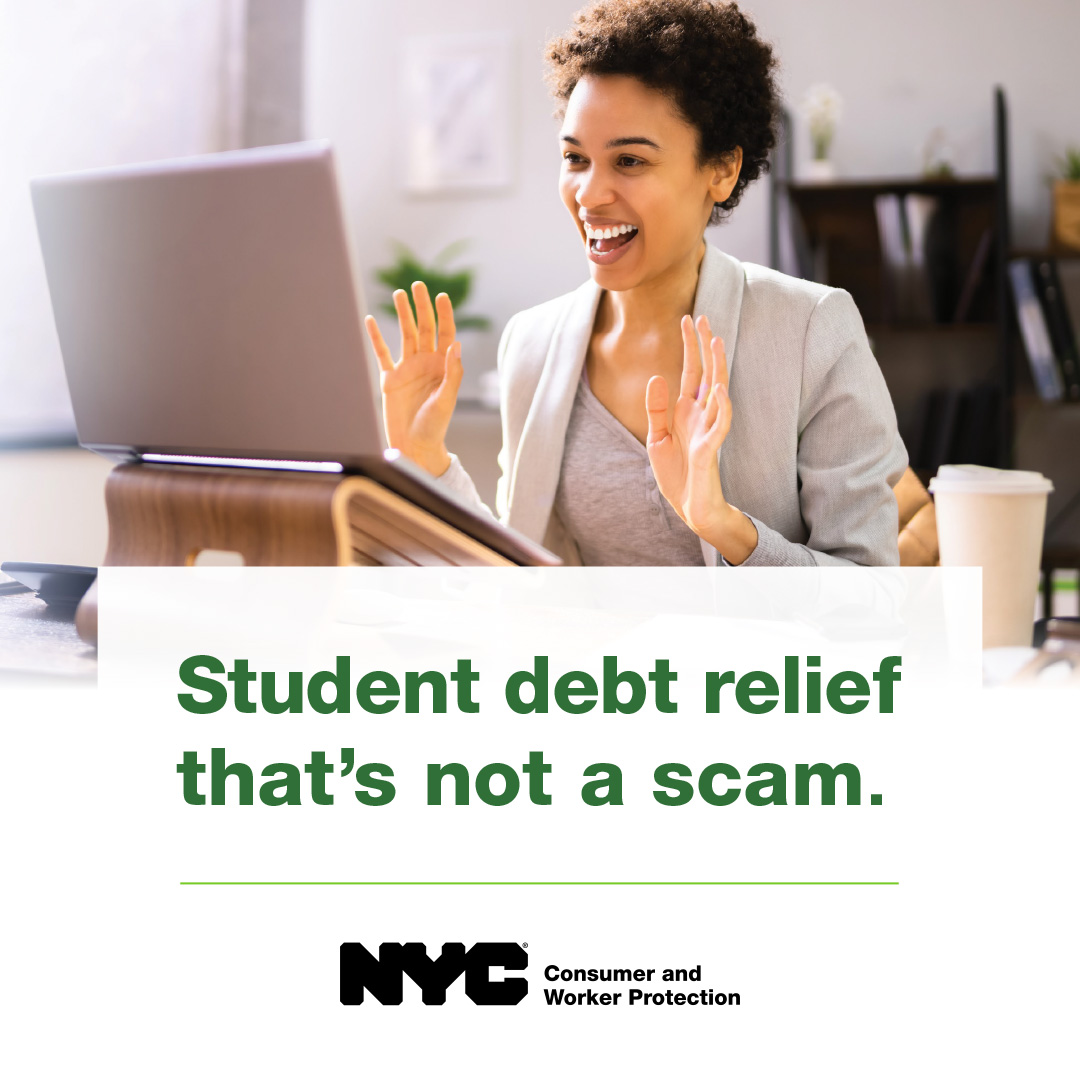 Young professional smiling at open laptop screen