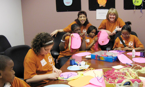Children join in mask-making fund with Selina Higgins, Director of Training, Design and Implementation and Magdalena Leszko, Child Protective Specialist in Staten Island