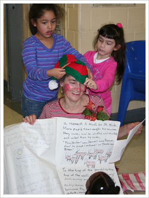 Santa’s helper gets some help from some of the children visiting their mothers at the CHIPP holiday party.