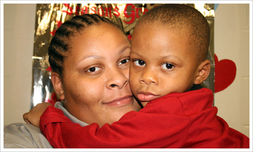 Together for the holidays, mother and son enjoy a hug.