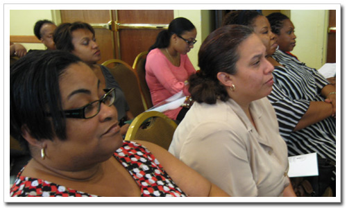 A section of the audience listens attentively to features of the new Website.