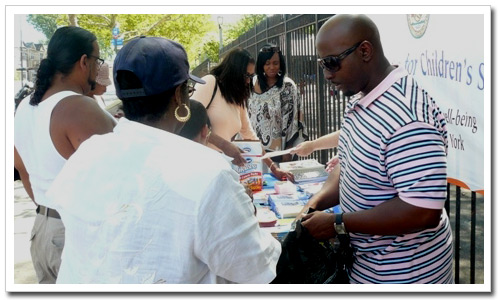 CPM Ducoste Lamoth, Jr (foreground) shares brochures with the public.