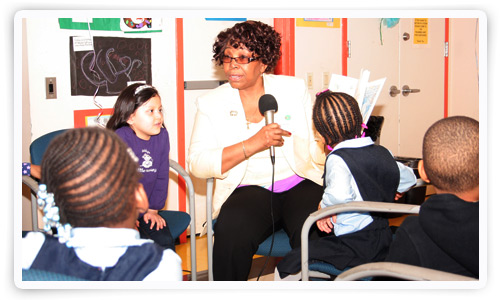 ACS staffer Francine Brotherson reading to the children. ACS staffer Francine Brotherson reading to the children.