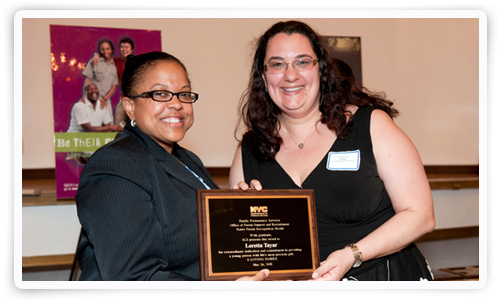 Foster parent Loretta Taylor receives her award from ACS Deputy Commissioner Lorraine Stephens. Foster parent Loretta Taylor receives her award from ACS Deputy Commissioner Lorraine Stephens.