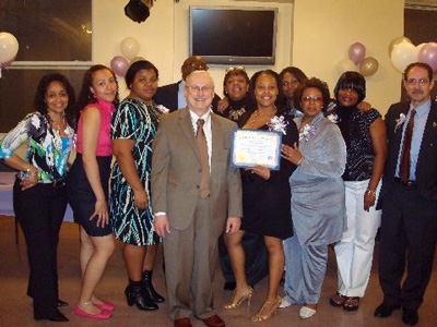 ACS Commissioner John Mattingly, (center) poses with new graduates and the staff of CWOP.