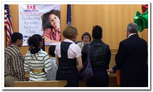 A family gathers before a court official at their adoption formalization ceremony in Queens last November.
