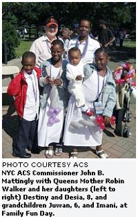 NYC ACS Commissioner John B. Mattingly with Queens Mother Robin Walker and her daughters (left to right) Destiny and Desia, 8, and grandchildren Juwan, 6, and Imani, at Family Fun Day. 