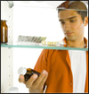 boy looking in medicine cabinet