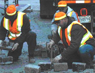 men repairing cobblestones