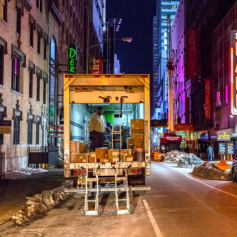Truck delivering goods during off-hours, after dark.