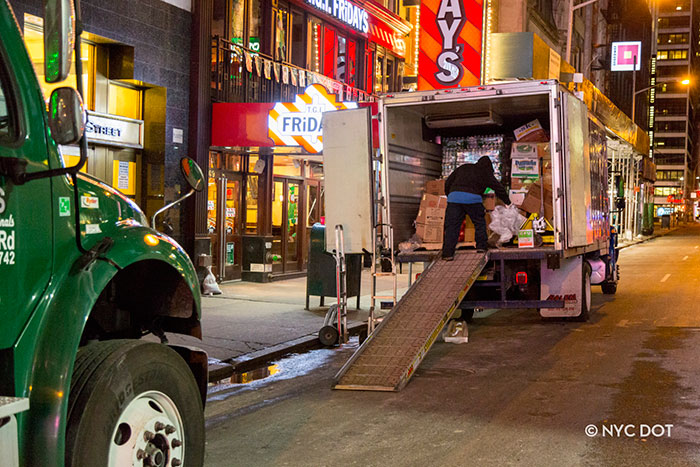 Truck Delivering goods on street in front of stores Truck Delivering goods on street in front of stores