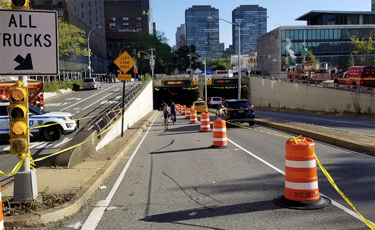 Orange barrels separate a bike lane from a vehicular travel lane on First Avenue during U N General Assembly.