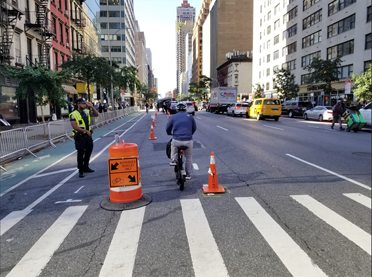 Orange cones and a barrel divide travel lanes for authorized vehicles and bikes on Second Avenue during the U N General Assembly.