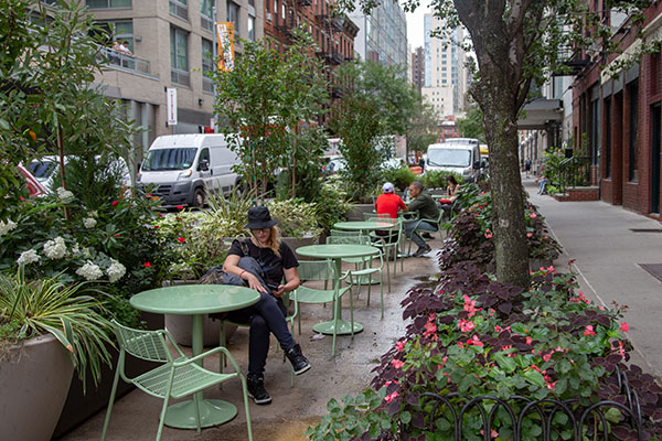 Street Seat area on W37th Street, Manhattan consisting of round tables, large flower pots and garden area. Street Seat area on W37th Street, Manhattan consisting of round tables, large flower pots and garden area.