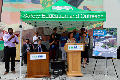 MOPD Commissioner Victor Calise, TLC Commissioner and Chair Meera Joshi at podium