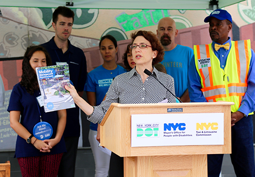 NYC DOT Commissioner Polly Trottenberg holding the new Mobility Management Resource Guide