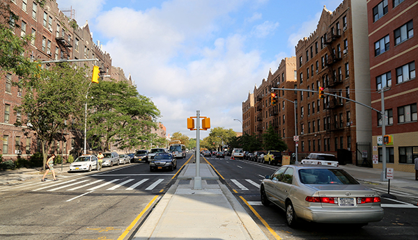 New mid-block concrete pedestrian island, traffic signal, and 20 MPH School Slow Zone