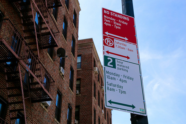 Signage designating adjusted metered parking regulations, ASP and No Standing zone hours