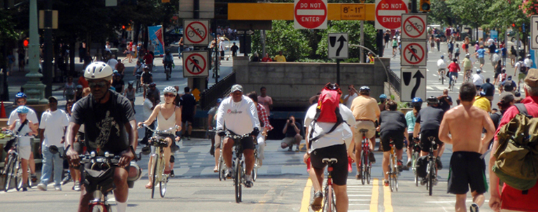 Photo of people biking and walking on the street