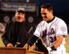 Hall of famer Johnnie Bench shows off his favorite team cap (D.S.N.Y.) while greeting future hall of famer Mike Piazza before the game