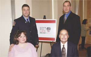 Firefighter John Jensen and former firefighter Joe Kazlauskas stand behind their bone marrow recipients, Brooke Williams and Glenn Hale.