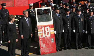 President George Bush and his wife, Laura, stand outside the &ldquo;Fort Pitt&rdquo; for a memorial service on 9/11. Beside them stands the door of the rig the members of Ladder 18 used to respond to the attacks.