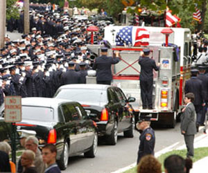 Firefighters salute fallen Firefighter Michael Reilly during his funeral procession in Ramsey, New Jersey.
