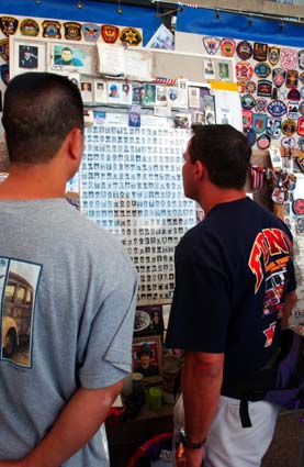 2 people looking at poster listing fallen firefighters