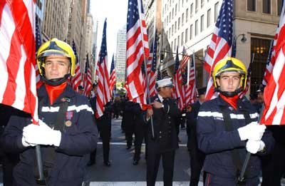 Italian firefighters marching in parade holding the American Flag