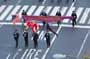 FDNY contingent marches holding American flags