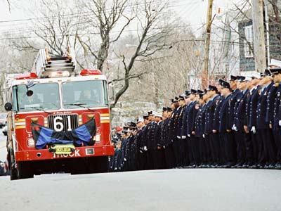 The casket of FDNY firefighter and member of the U.S. Army Reserve 69th Infantry Christian Engeldrum is escorted to St. Benedict's Roman Catholic Church in the Bronx 
