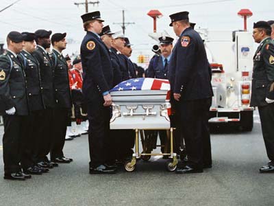 Firefighters stands the casket of FDNY firefighter and a member of the U.S. Army Reserve 69th Infantry Christian Engeldrum 