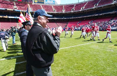 Fire Commissioner Nicholas Scoppetta and the Honor Guard cheer the Bravest as they take the field.