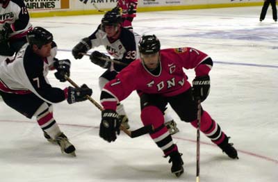 Lieutenant Tom Frizalone (C) evades two NYPD players.