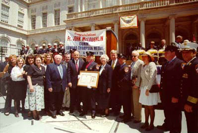 Firefighter John J. McLoughlin poses after receiving the Chief Joseph B. Martin Medal