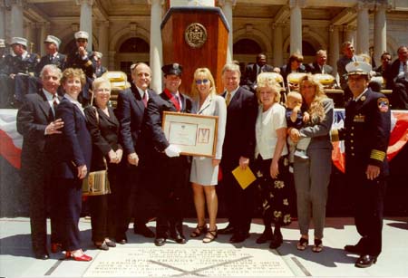 FF Frank E. Muzio poses after receiving the Edith B. Goldman Medal