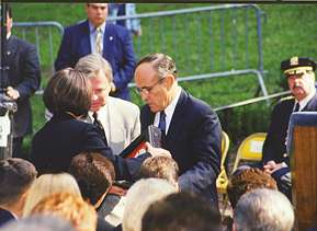 Mayor Rudolph W. Giuliani presents a family member with the 