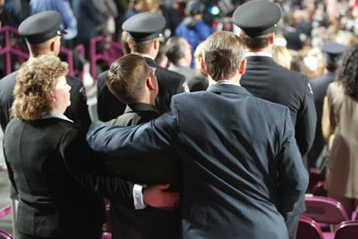 Honor Families and Honor Escorts stand for the closing prayer. 