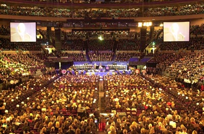 View from the rear of Madison Square Garden looks over the crowd to the stage in the distance.