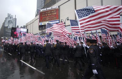 Madison Square Garden Can be seen in the background over the American flags carried by Firefighters from all over the world.