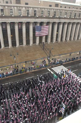 Firefighters with American flags march along 9th Avenue