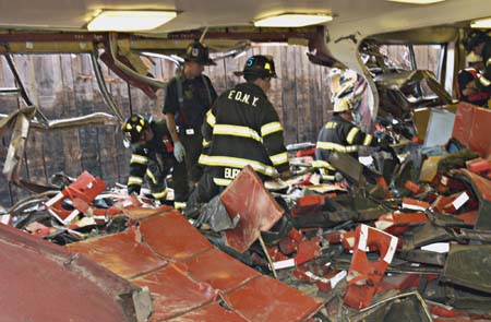 Firefighters sift through the wreckage.