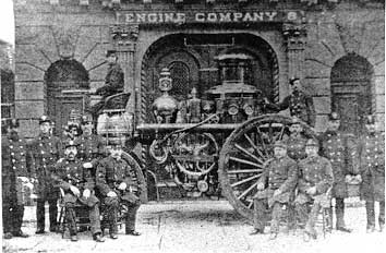 Members of Engine 8 in front of quarters with their rig