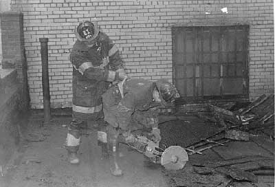 Members using a Partner Saw on roof