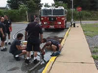 Firefighters at the FDNY Bureau of Training are hooking preparing to supply foam from a pumper during a training exercise