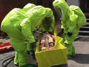 Firefighters in full chemical protective suits perform drills at the Bureau of Training