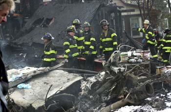 Firefighters make their way through the debris.