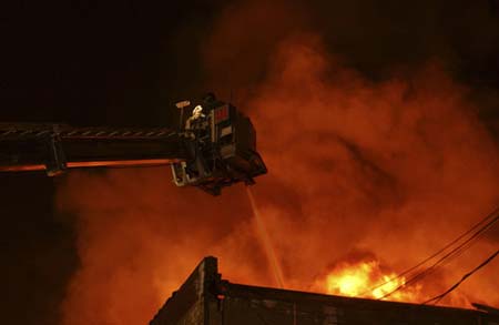 Firefighters battling blaze from a tower ladder