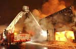 Tower ladder hitting the front of burning building