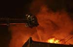 Firefighters battling blaze from a tower ladder